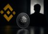 ASTEROID-Memecoin vor Binance-Logo und Silhouette eines ehemaligen Mitarbeiters