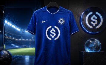 Circle wird Trikotsponsor des FC Chelsea und bringt USDC in die Premier League Blaues Chelsea-Trikot mit USDC-Symbol vor beleuchtetem Fußballstadion als Darstellung der Partnerschaft zwischen Circle und dem FC Chelsea.