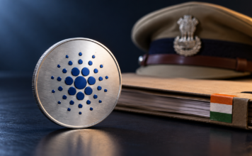 Cardano vor Mega-Adoption? Indiens Polizei plant ADA-Einsatz Silberne Medaille mit Cardano-Logo vor einer Aktenmappe mit indischen Nationalfarben und einer Polizeimütze.