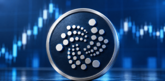 Großes IOTA-Logo auf einer dunkelblauen Münze vor einem abstrahierten Kurschart.