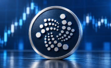 Großes IOTA-Logo auf einer dunkelblauen Münze vor einem abstrahierten Kurschart.