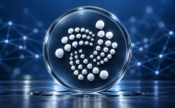 IOTA: Protokoll 37 ist live – diese Neuerungen bringt das Update IOTA-Logo auf einer gläsernen Scheibe vor blauem Hintergrund mit Netzwerkverbindungen.