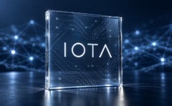 IOTA aktiviert Protokoll 38: Das bringt das neue Mainnet-Update IOTA-Schriftzug auf einer Glasplatte vor einem blauen Netzwerk aus verbundenen Knoten.