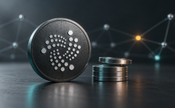 IOTA plant Validator-Strafen: Fehler könnten die gesamte Belohnung kosten IOTA-Logo auf einer dunklen Münze neben metallischen Scheiben als Symbol für Validator-Belohnungen.