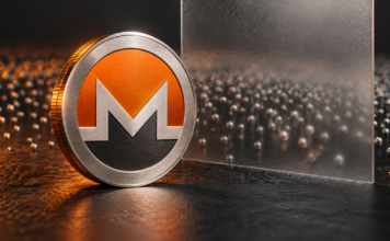 Monero: Privacy-Upgrade FCMP++ erreicht Meilenstein Silberne Monero-Münze vor einer Milchglasscheibe und zahlreichen kleinen Metallkugeln auf dunklem Hintergrund.